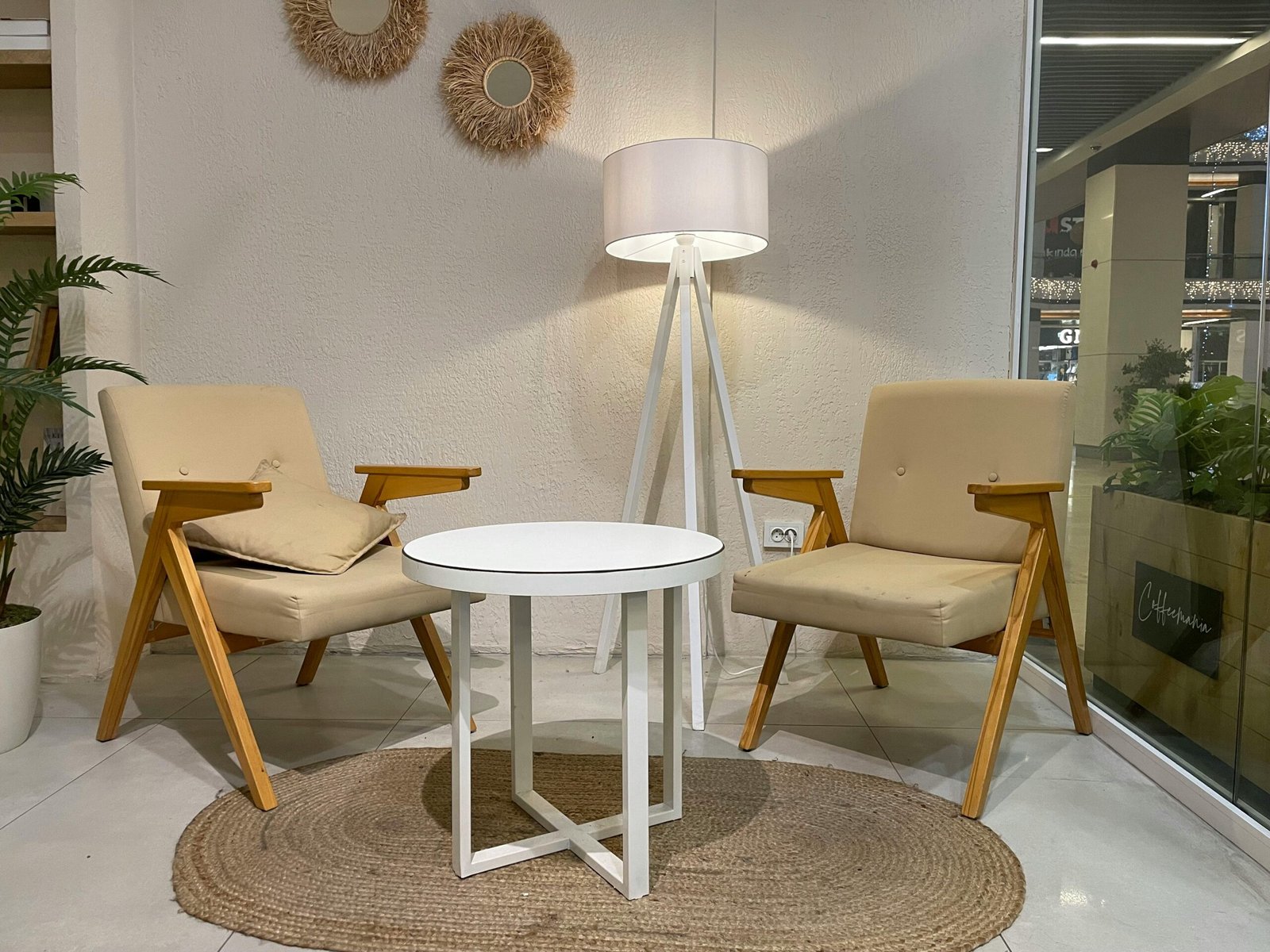 Elegant modern seating arrangement with round table and wooden chairs in chic Istanbul cafe.