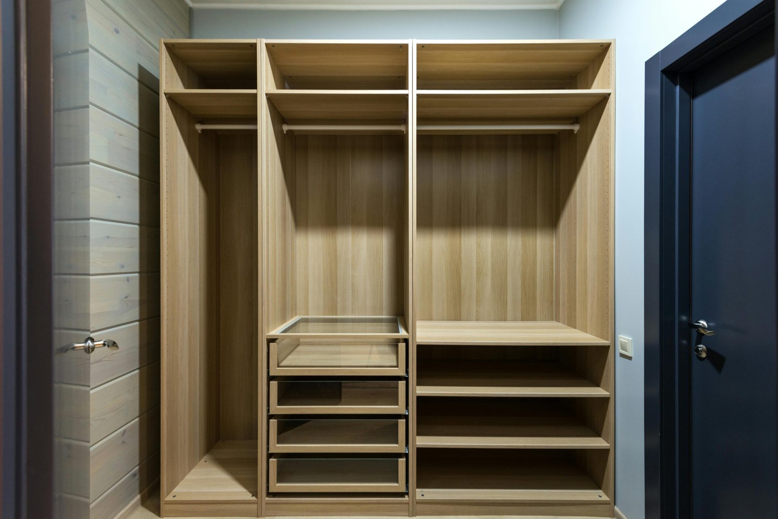Contemporary wooden wardrobe with shelves and drawers, ideal for minimalist interior design.