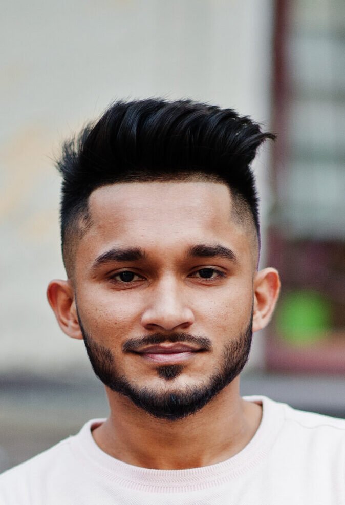 stylish indian beard man at pink t shirt. india model posed outd